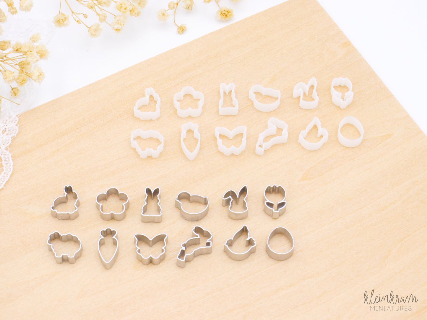 Two sets of miniature 1:6 scale easter deco cookie cutters: the top group shows unpainted white cutters, and the bottom group shows the same shapes painted silver. Each group includes cutters shaped like a bunny in profile, a flower, a standing bunny, a chick, a bunny head, a tulip, a sheep, a carrot, a butterfly, a hopping bunny, a bird, and an egg.