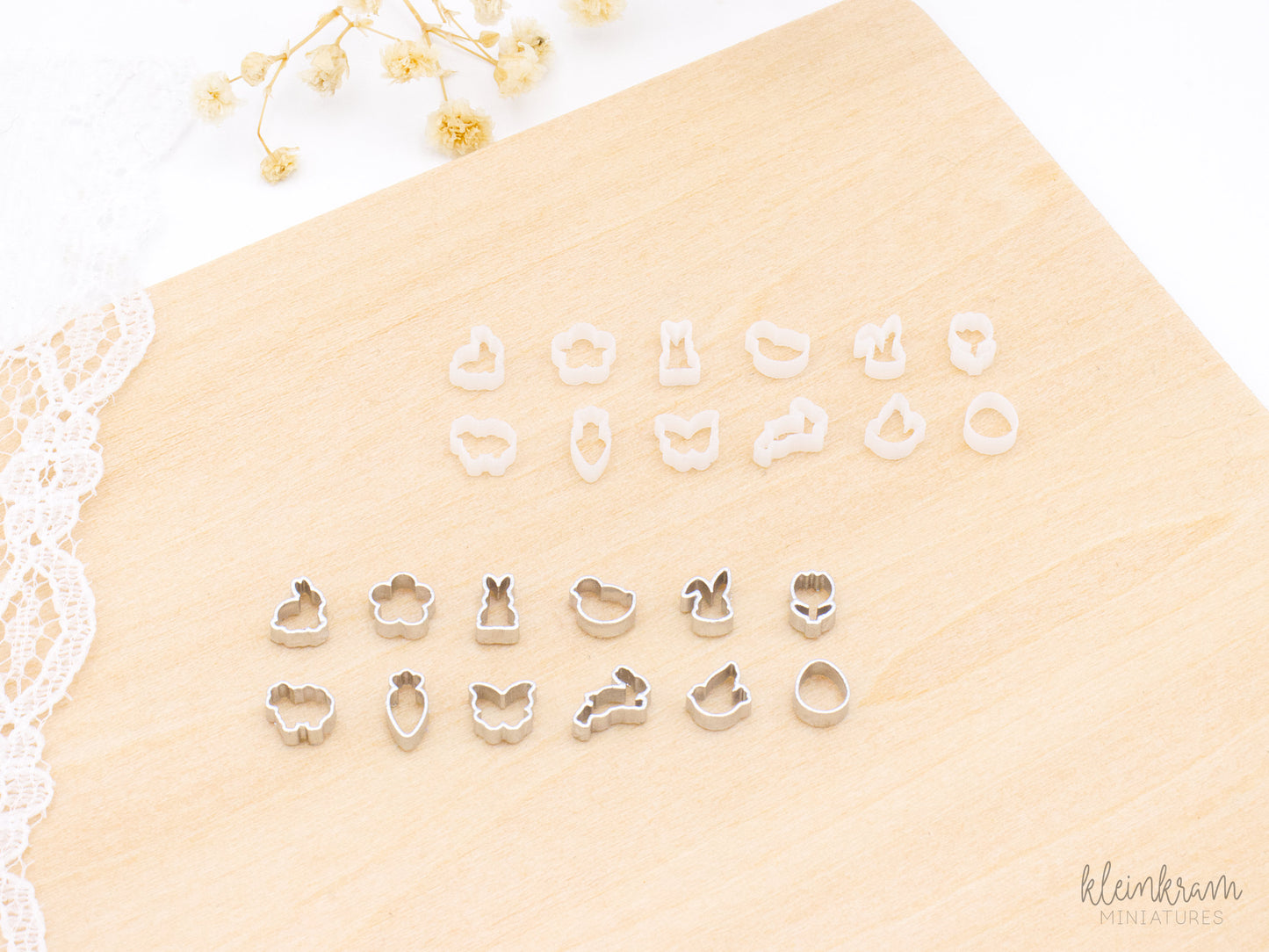 Two sets of miniature 1:12 scale deco cookie cutters: the top group shows unpainted white cutters, and the bottom group shows the same shapes painted silver. Each group includes cutters shaped like a bunny in profile, a flower, a standing bunny, a chick, a bunny head, a tulip, a sheep, a carrot, a butterfly, a hopping bunny, a bird, and an egg.