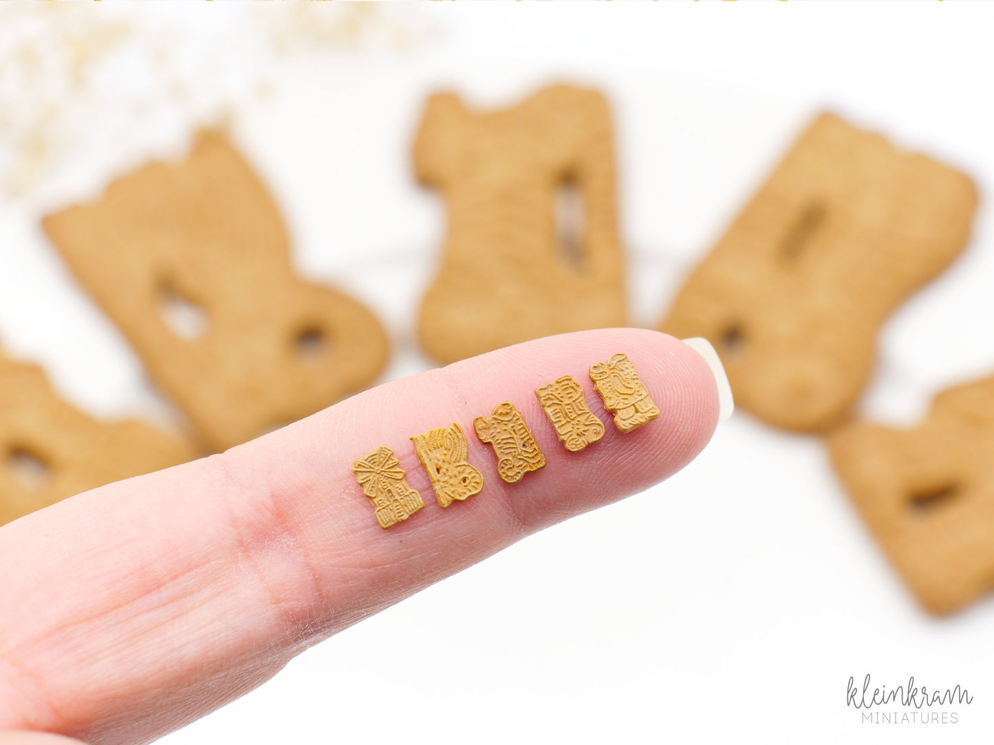 Miniature Speculaas Christmas Cookies in 1:12 scale on a finger